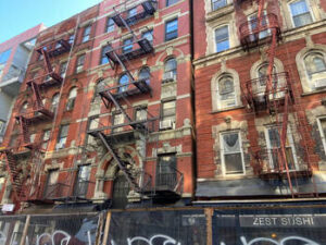 Nicer brick tenements still stand in the Bowery. The wooden ones are gone.